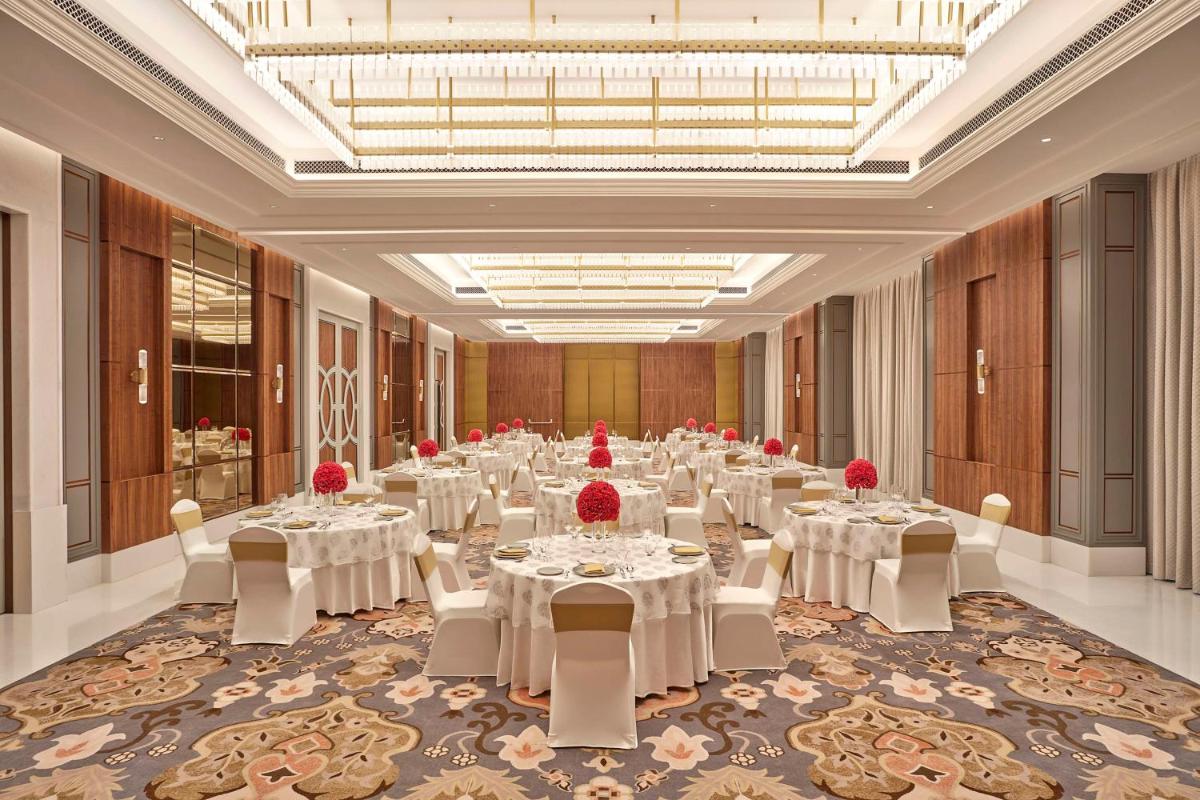 a large banquet hall with white tables and chairs at Doubletree By Hilton Bengaluru Whitefield in Bengaluru