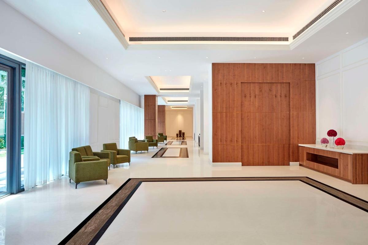 a lobby with chairs and a waiting room at Doubletree By Hilton Bengaluru Whitefield in Bengaluru