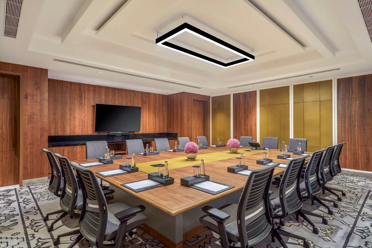 a large conference room with a large table and chairs at Doubletree By Hilton Bengaluru Whitefield in Bengaluru