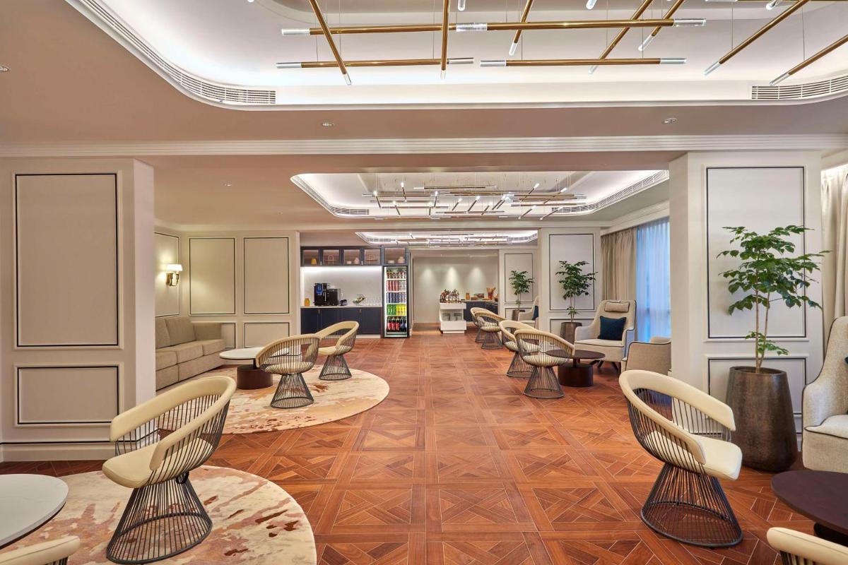 a salon with chairs and tables and a waiting room at Doubletree By Hilton Bengaluru Whitefield in Bengaluru