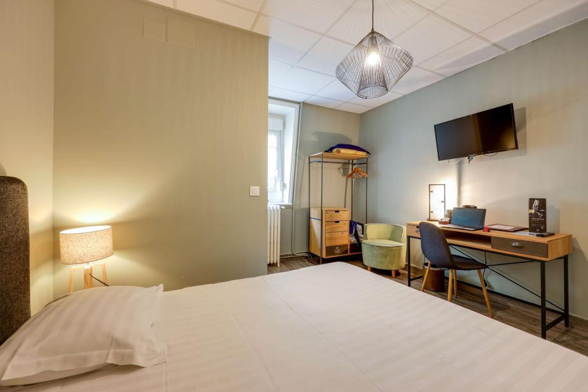 Un ou plusieurs lits dans un hébergement de l'établissement BRIT HOTEL & SPA Le Roc au Chien
