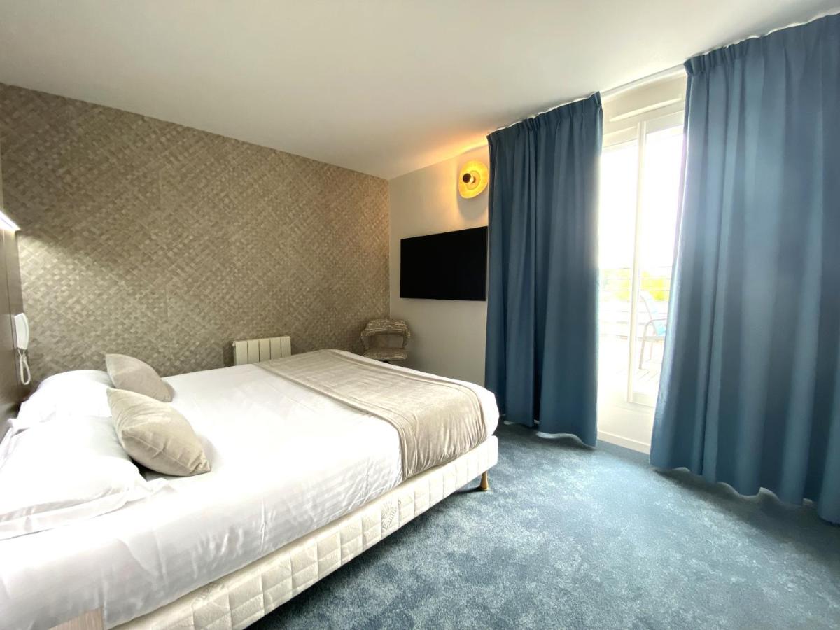 Un ou plusieurs lits dans un hébergement de l'établissement Brit Hotel Piscine & Spa - Fougères