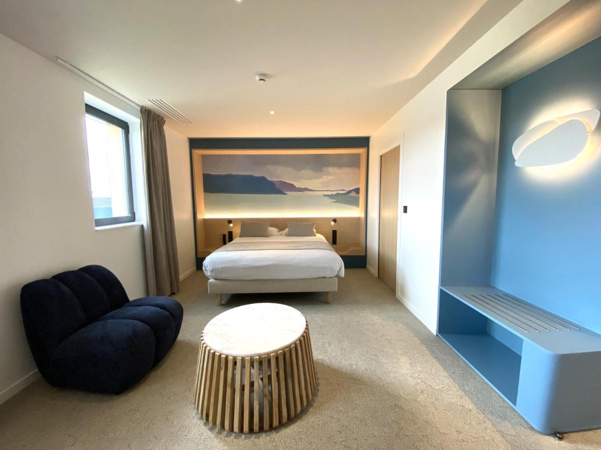 Un ou plusieurs lits dans un hébergement de l'établissement Brit Hotel Piscine & Spa - Fougères