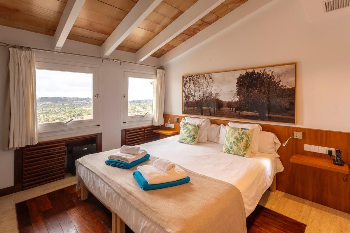 Cama o camas de una habitación en Can Cota Boutique - Turismo de interior