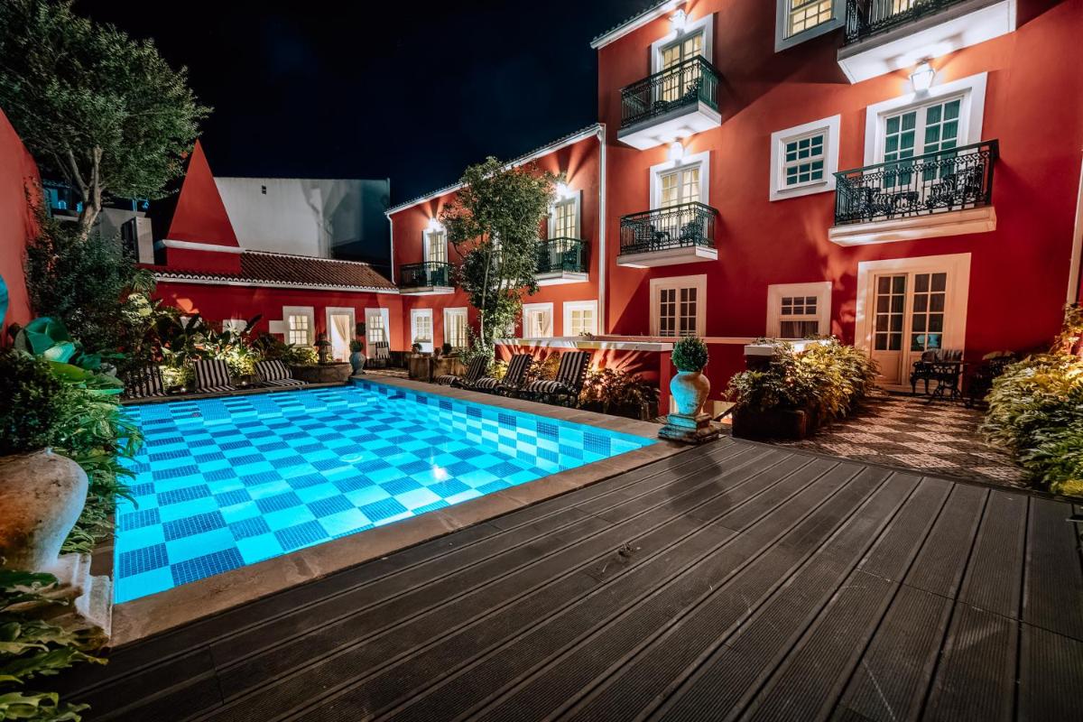 uma piscina em frente a um prédio à noite em Boutique Hotel Teatro em Angra do Heroísmo