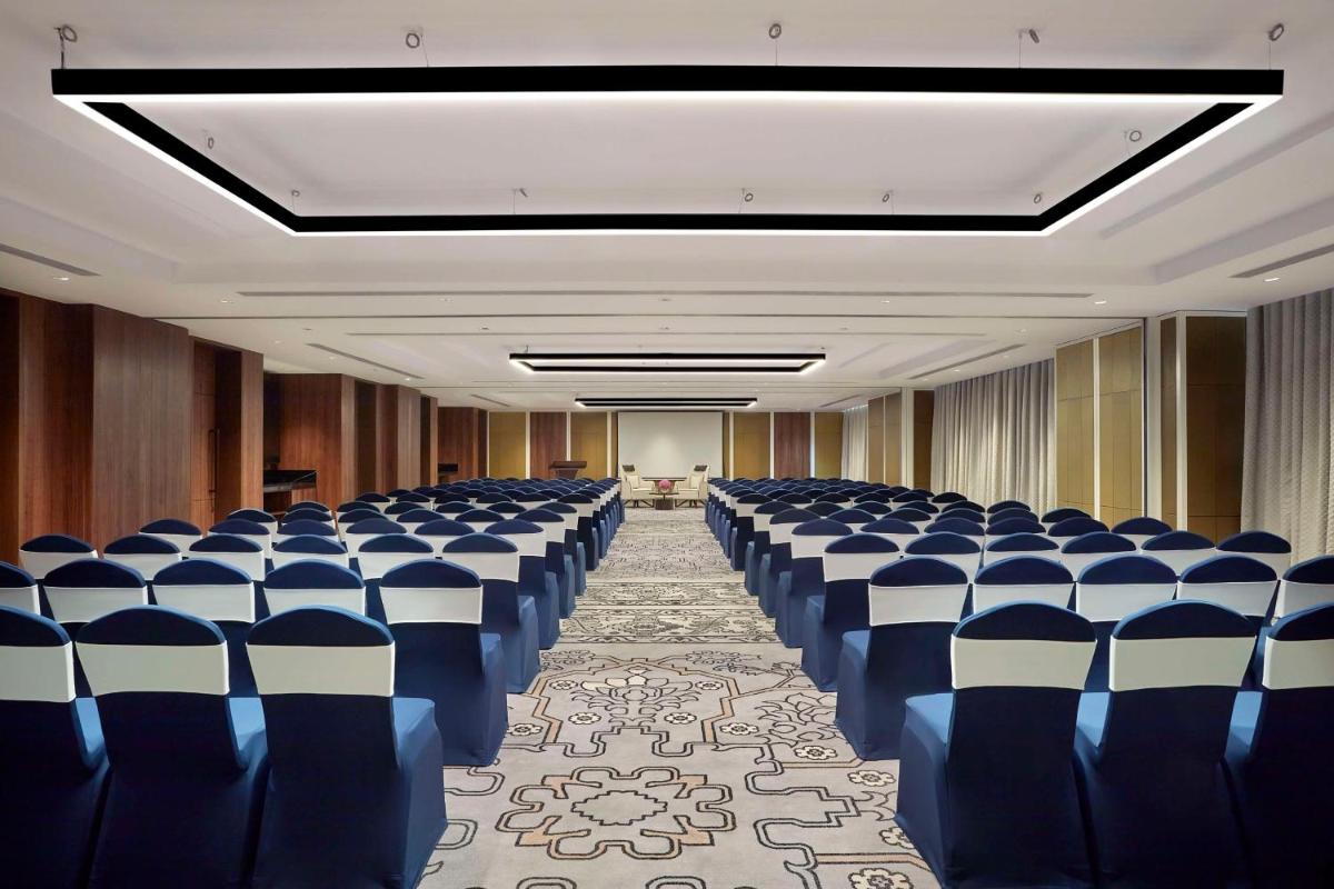 a conference room with blue and white chairs in it at Doubletree By Hilton Bengaluru Whitefield in Bengaluru