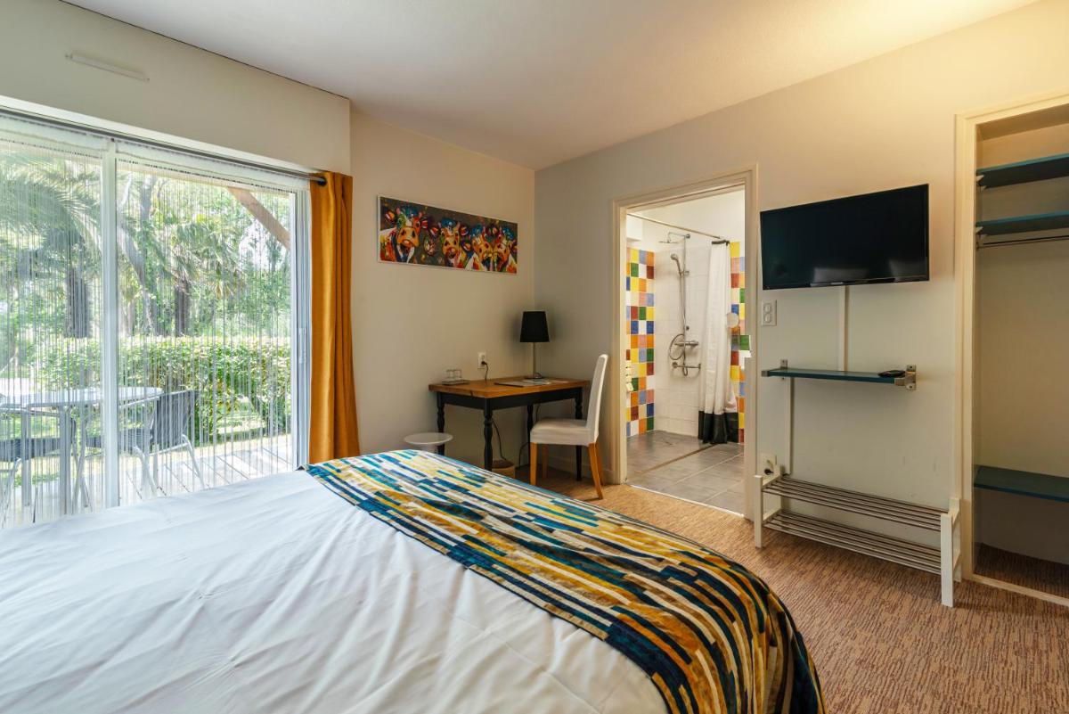 Un ou plusieurs lits dans un hébergement de l'établissement Carnac Lodge Hotel & Spa