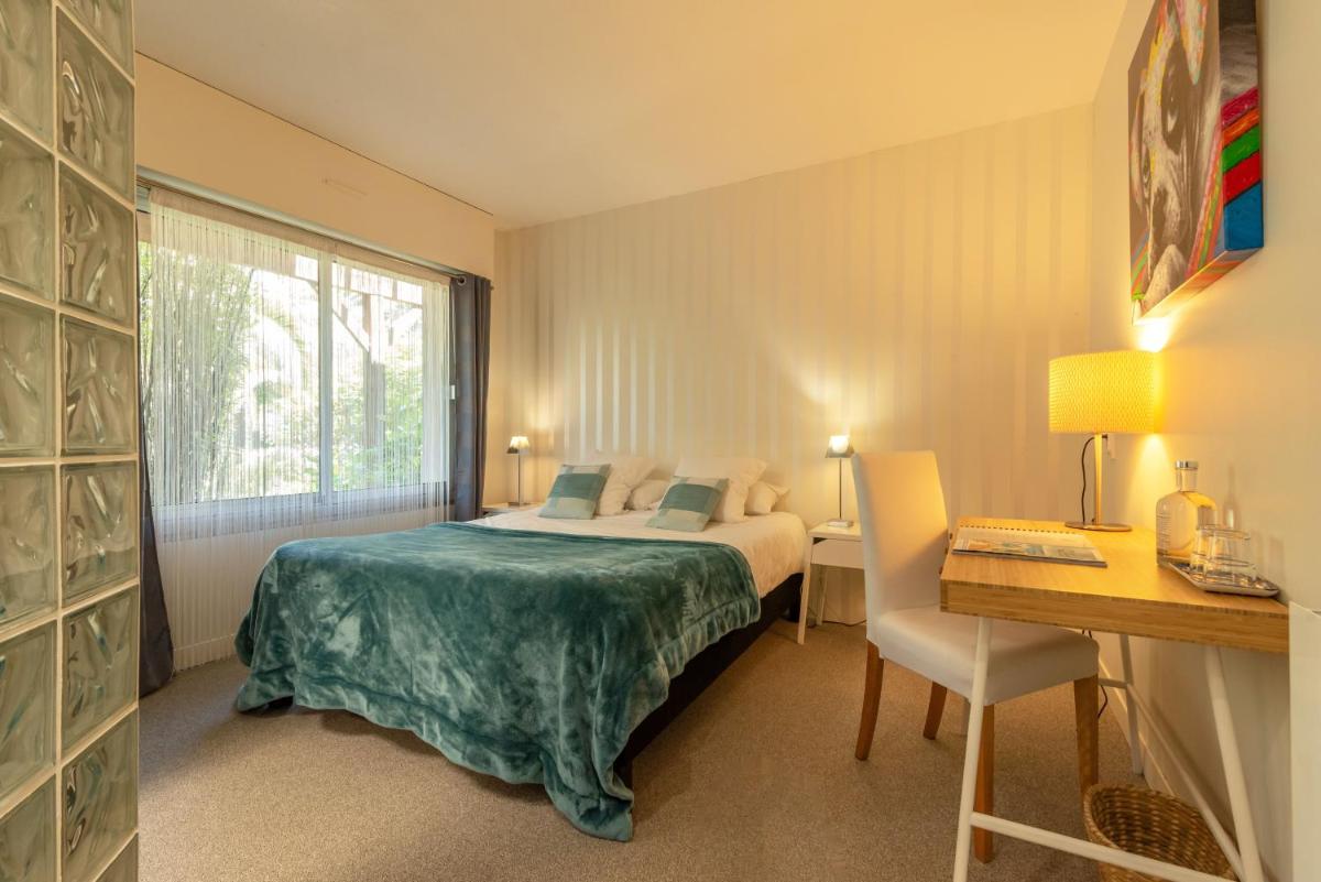Un ou plusieurs lits dans un hébergement de l'établissement Carnac Lodge Hotel & Spa