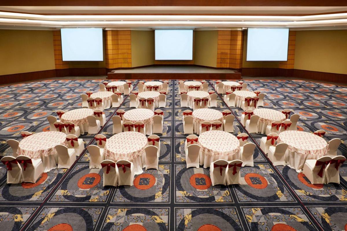 a room with tables and chairs on the floor at Hyderabad Marriott Hotel & Convention Centre in Hyderabad