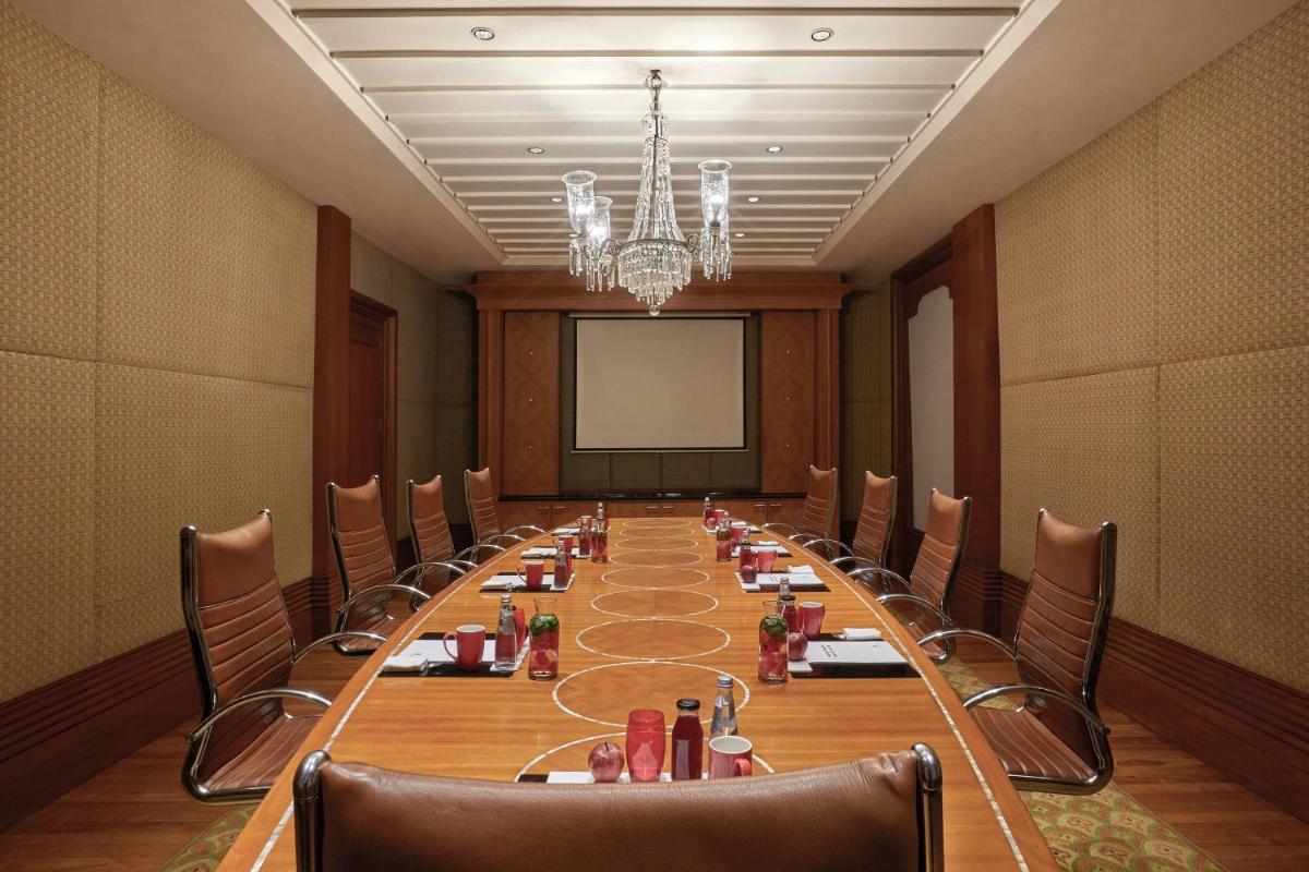 a large boardroom with a long table and chairs at Hyderabad Marriott Hotel & Convention Centre in Hyderabad