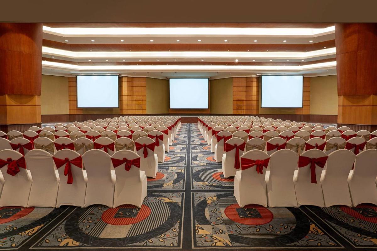 an empty conference room with rows of chairs in it at Hyderabad Marriott Hotel & Convention Centre in Hyderabad