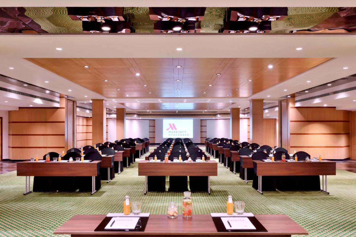 a conference room with rows of tables and chairs at Hyderabad Marriott Hotel & Convention Centre in Hyderabad