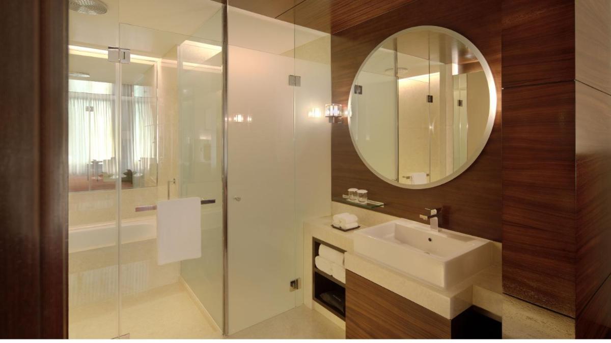 a bathroom with a sink and a mirror at JW Marriott Pune in Pune