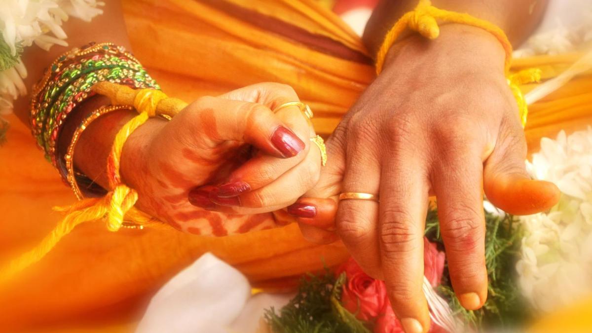 a woman wearing rings and bracelets on her hands at Holiday Inn Agra MG Road an IHG Hotel in Agra