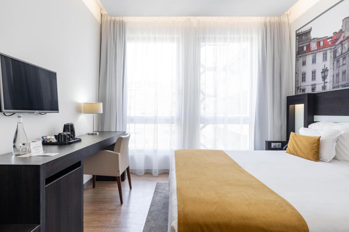 Uma cama ou camas num quarto em Jupiter Lisboa Hotel - Rooftop & Spa