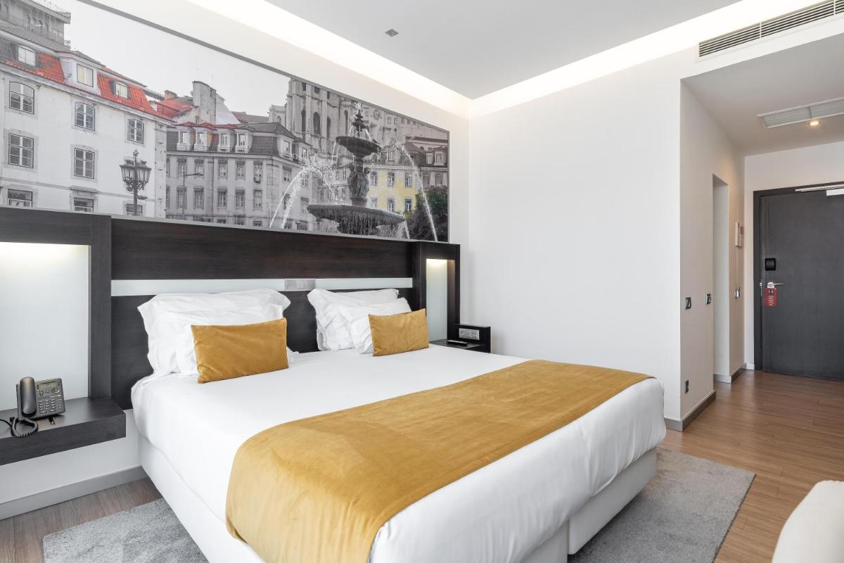 Uma cama ou camas num quarto em Jupiter Lisboa Hotel - Rooftop & Spa