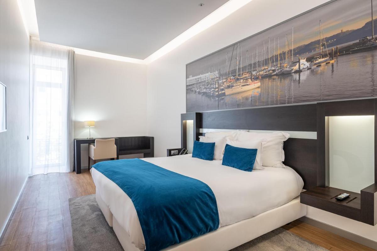 Uma cama ou camas num quarto em Jupiter Lisboa Hotel - Rooftop & Spa