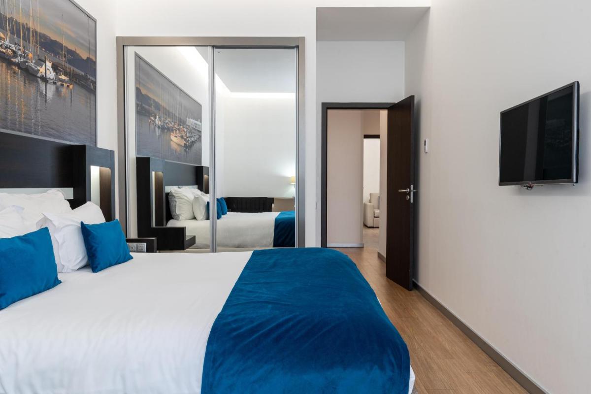 Uma cama ou camas num quarto em Jupiter Lisboa Hotel - Rooftop & Spa