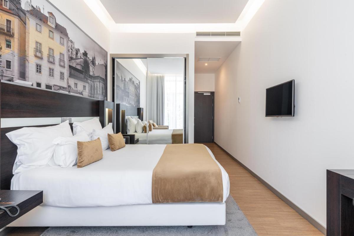 Uma cama ou camas num quarto em Jupiter Lisboa Hotel - Rooftop & Spa