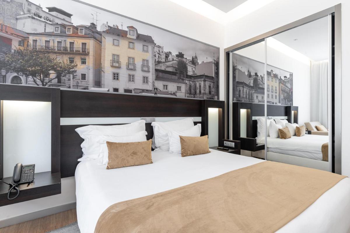 Uma cama ou camas num quarto em Jupiter Lisboa Hotel - Rooftop & Spa