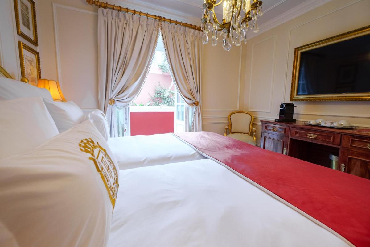 Uma cama ou camas num quarto em Boutique Hotel Teatro