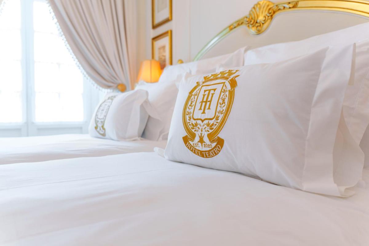 Uma cama ou camas num quarto em Boutique Hotel Teatro