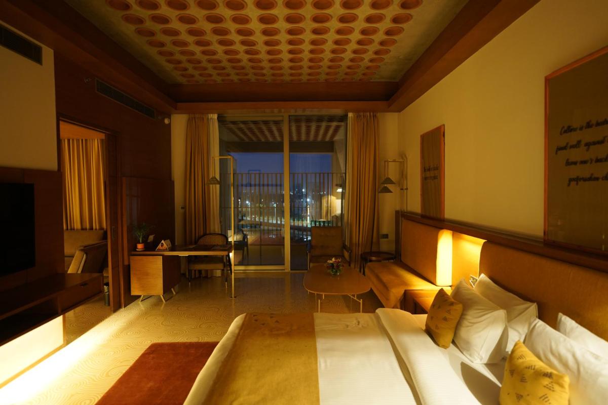 a hotel room with a bed and a view of the city at The Centrum in Lucknow