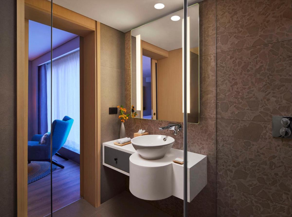 a bathroom with a sink and a mirror at Hyatt Centric Hebbal Bengaluru in Bengaluru