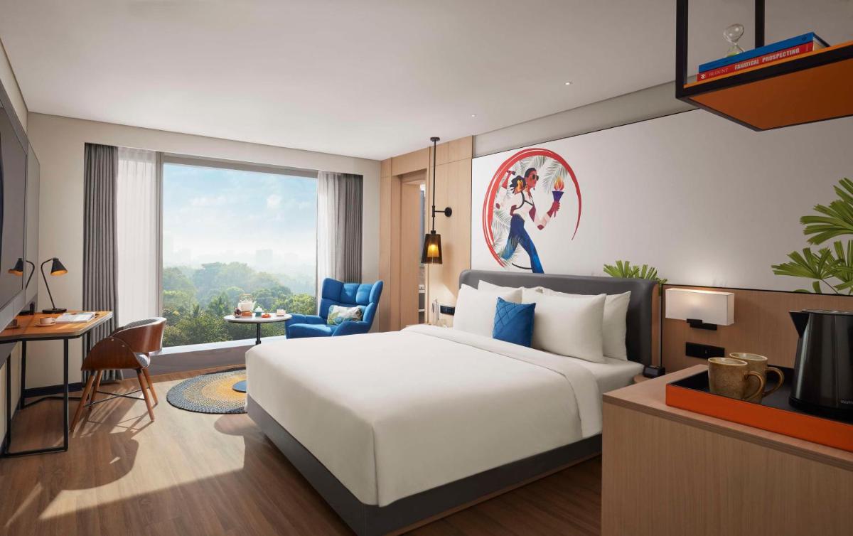 a bedroom with a white bed and a large window at Hyatt Centric Hebbal Bengaluru in Bengaluru