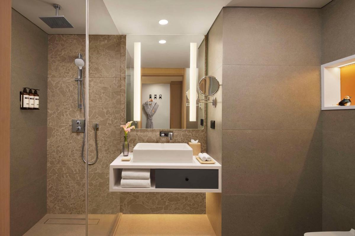 a bathroom with a sink and a shower at Hyatt Centric Hebbal Bengaluru in Bengaluru