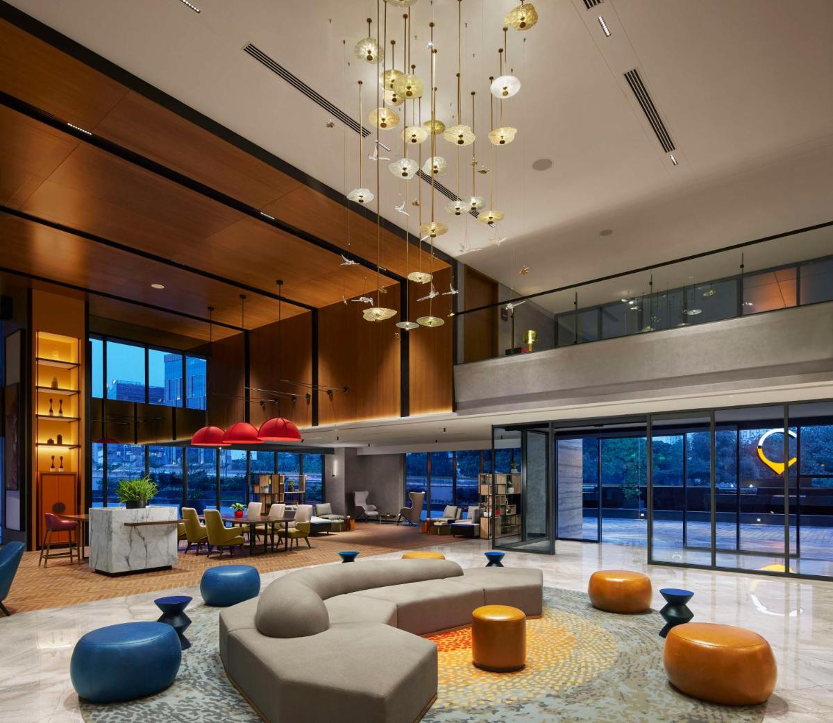 a large living room with a couch and chairs at Hyatt Centric Hebbal Bengaluru in Bengaluru