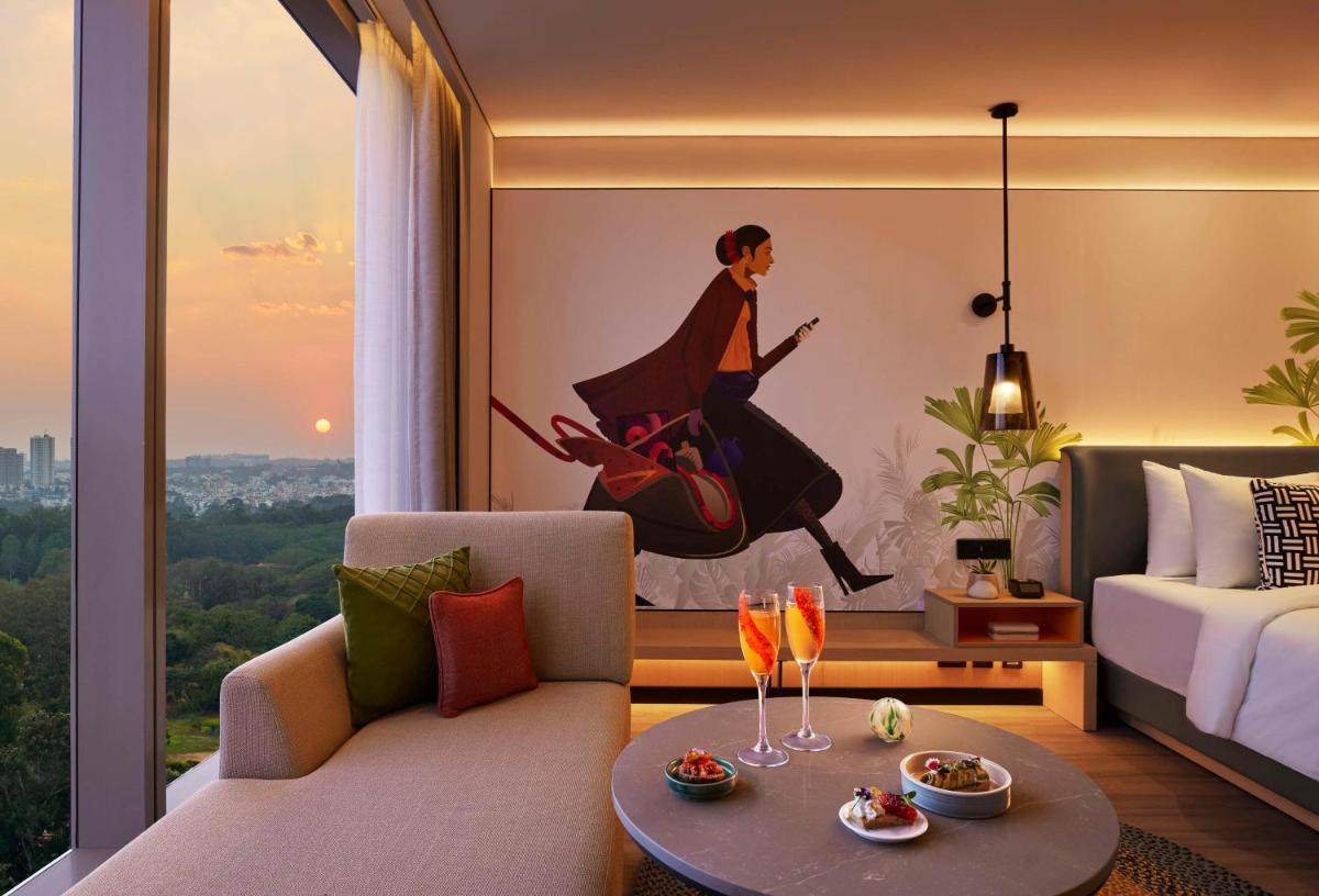 a hotel room with a mural of a woman running at Hyatt Centric Hebbal Bengaluru in Bengaluru