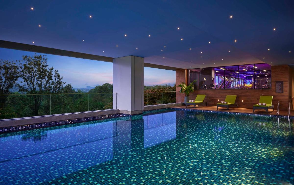 a swimming pool in a house with a view at Hyatt Centric Hebbal Bengaluru in Bengaluru
