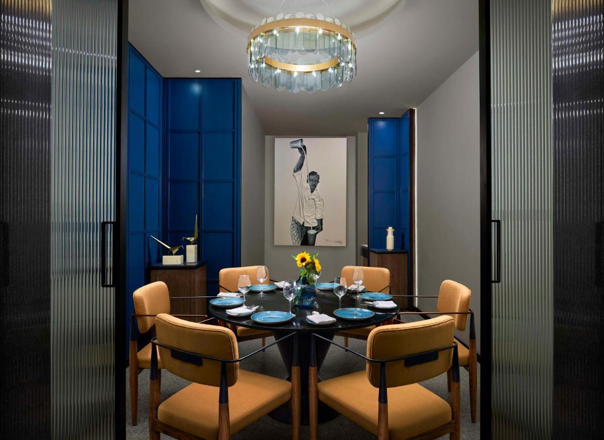 a dining room with a table and chairs at Hyatt Centric Hebbal Bengaluru in Bengaluru