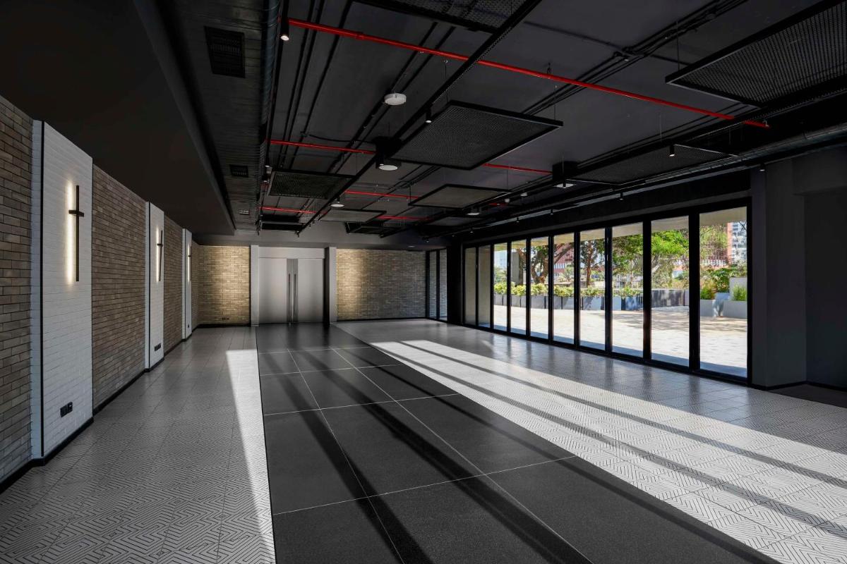 an empty hallway with a large room with windows at Hyatt Centric Hebbal Bengaluru in Bengaluru
