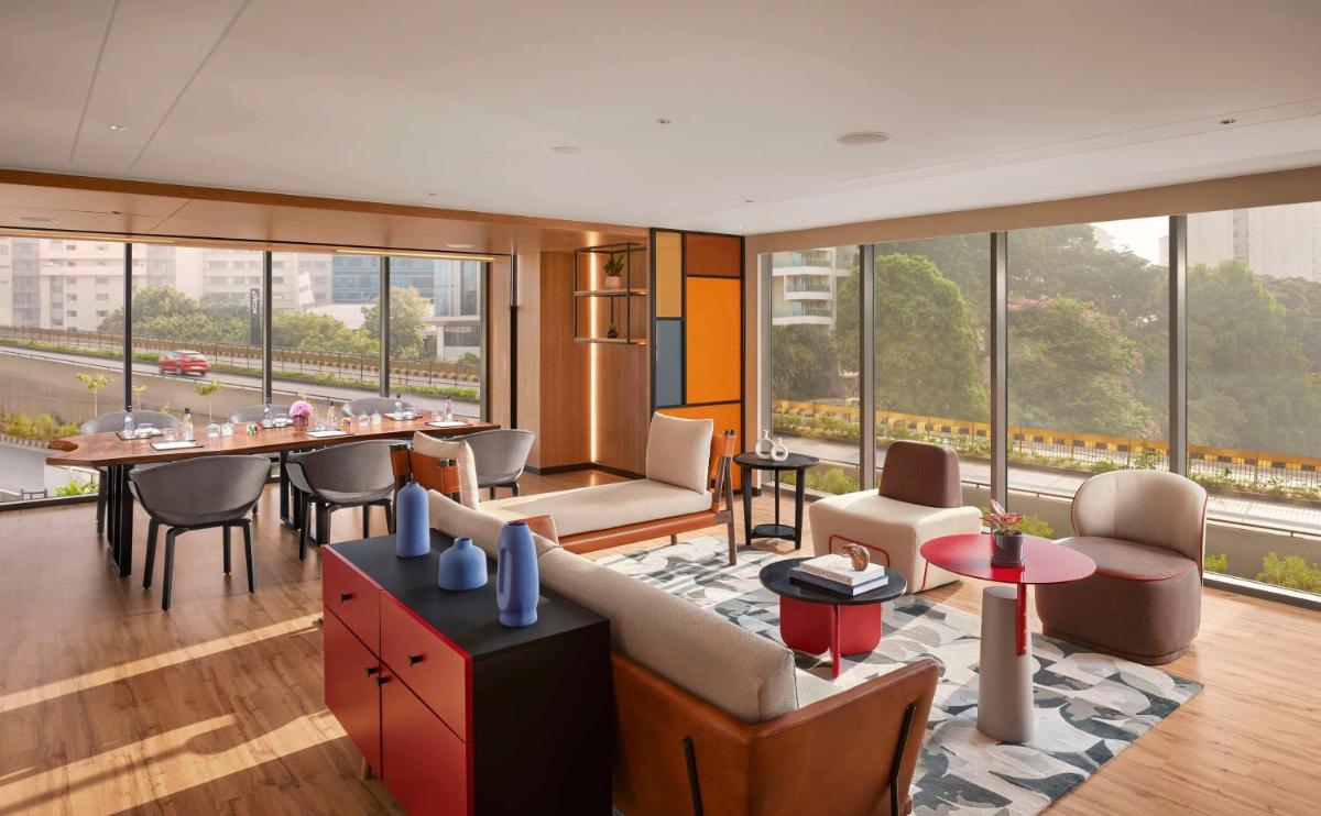a living room with a couch and a table at Hyatt Centric Hebbal Bengaluru in Bengaluru