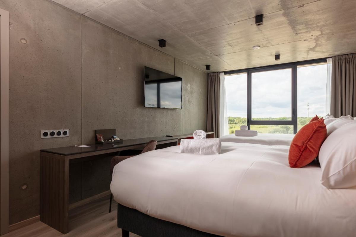 Un ou plusieurs lits dans un hébergement de l'établissement Ki Space Hotel & Spa - near Disneyland Paris
