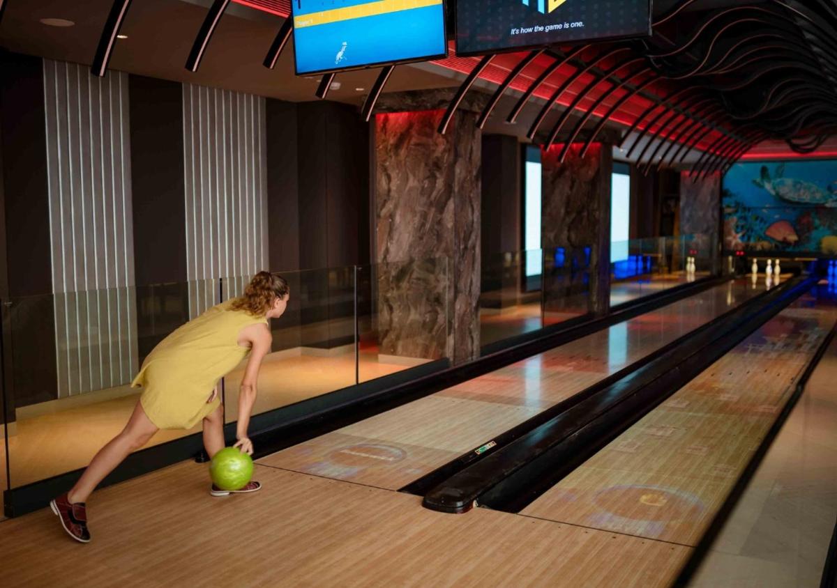 a woman playing a ball in a bowling alley at JW Marriott Goa in Vagator a woman playing a ball in a bowling alley at JW Marriott Goa in Vagator