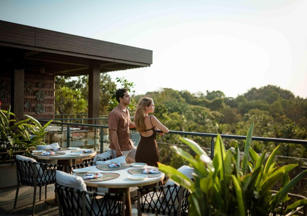a man and a woman standing on a balcony at JW Marriott Goa in Vagator a man and a woman standing on a balcony at JW Marriott Goa in Vagator