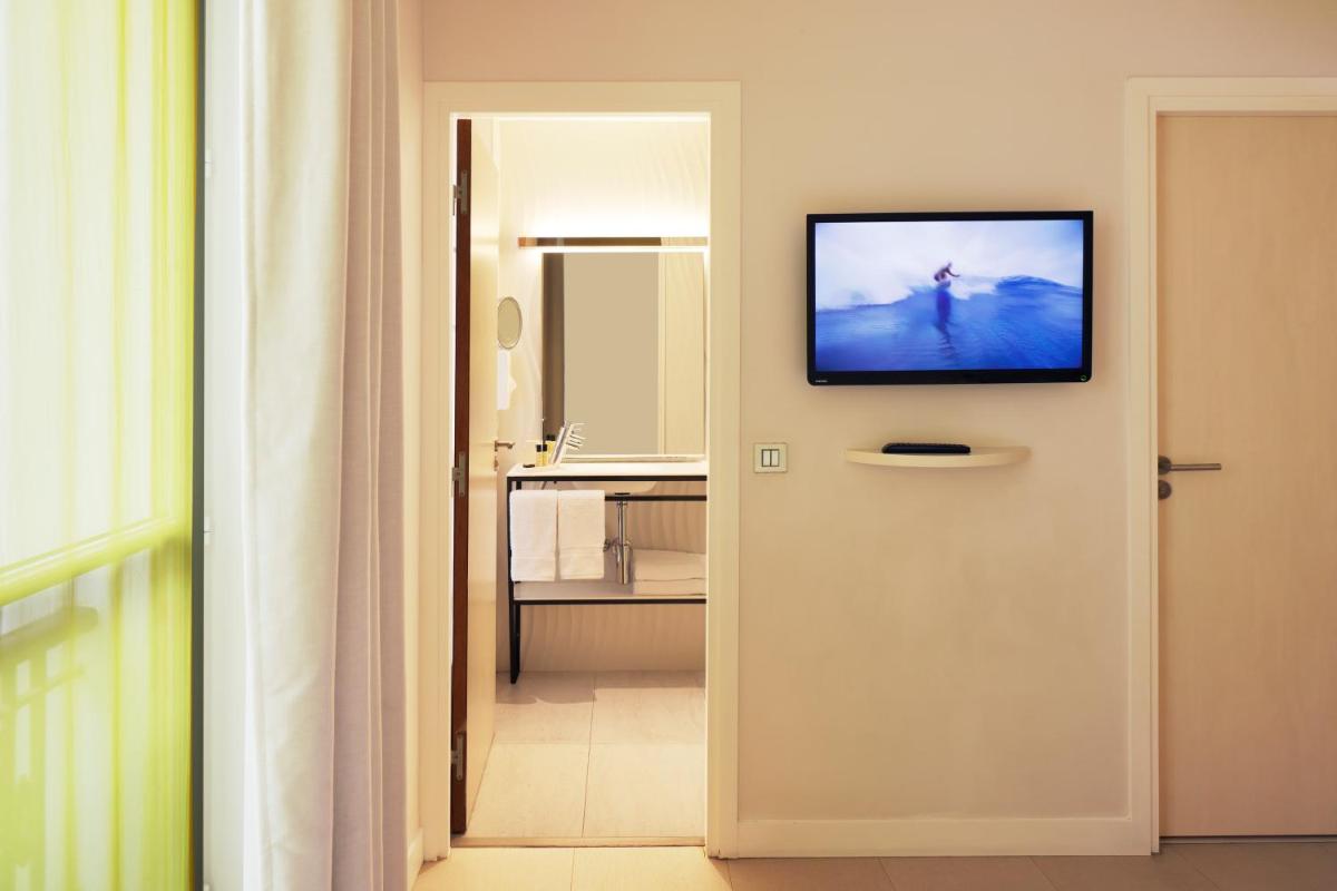 Télévision ou salle de divertissement dans l'établissement Hotel Eden