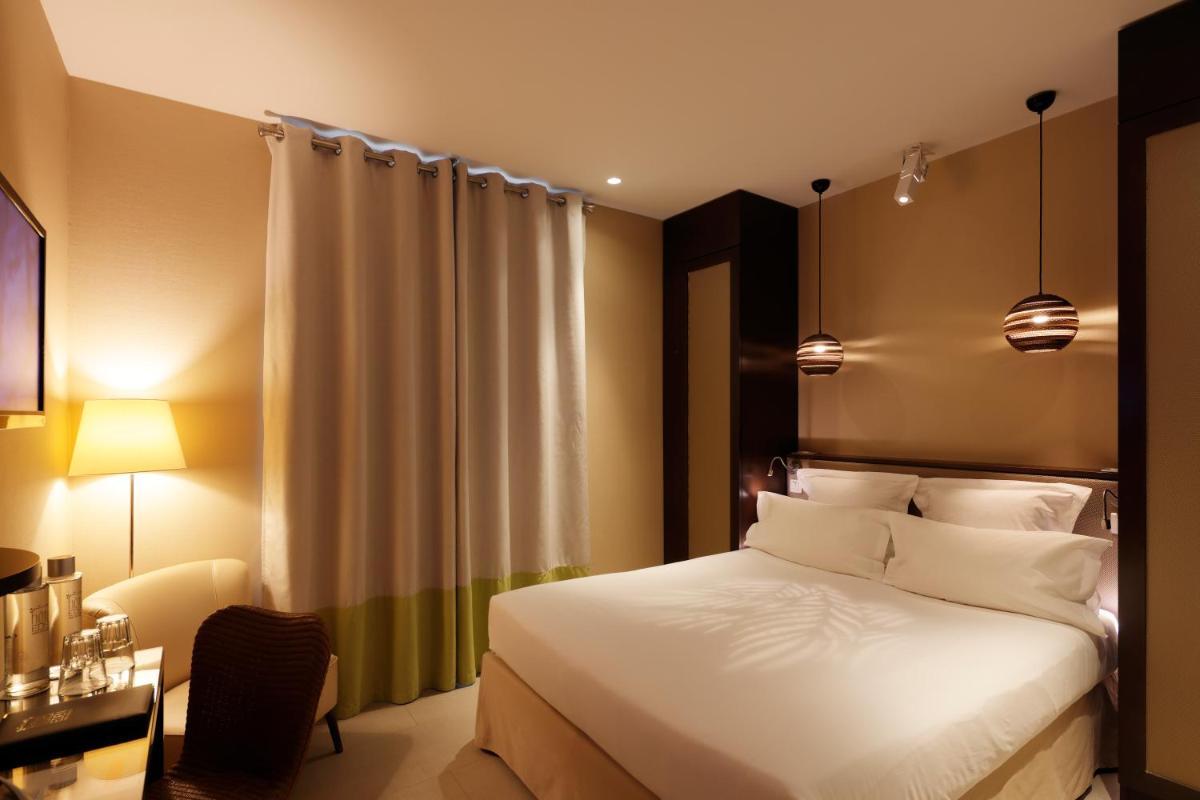 Un ou plusieurs lits dans un hébergement de l'établissement Hotel Eden