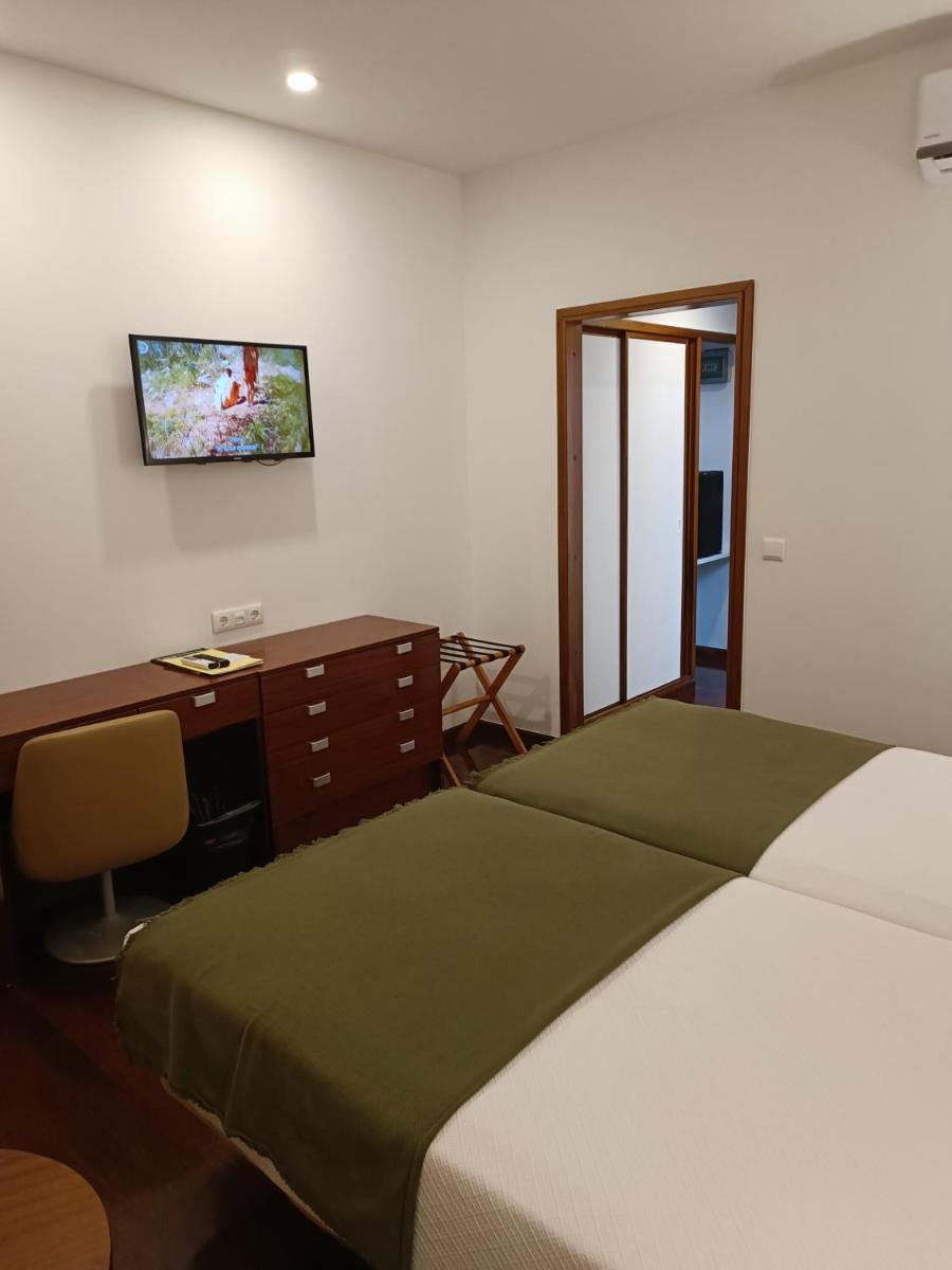 Uma cama ou camas num quarto em Hotel Porto Santo & Spa