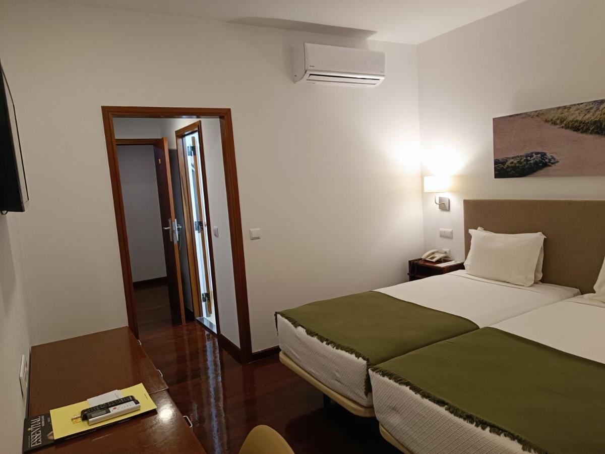 Uma cama ou camas num quarto em Hotel Porto Santo & Spa