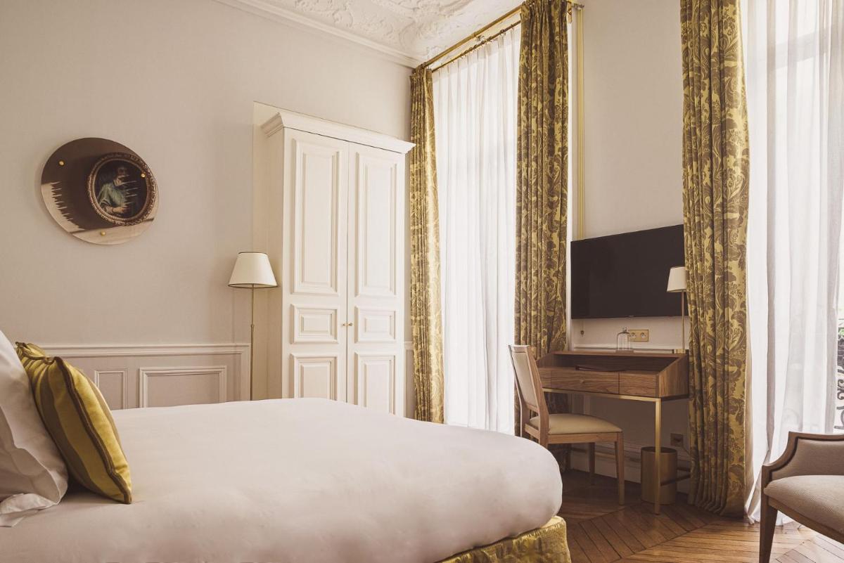Un ou plusieurs lits dans un hébergement de l'établissement Hôtel Alfred Sommier