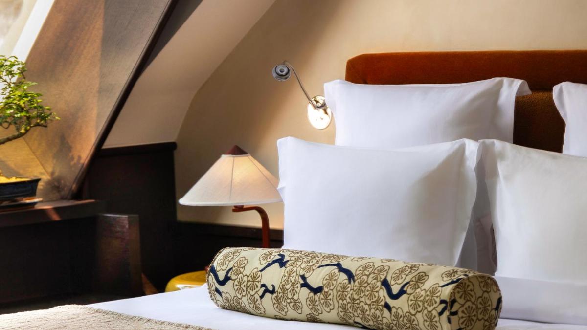 Un ou plusieurs lits dans un hébergement de l'établissement Hotel Hana