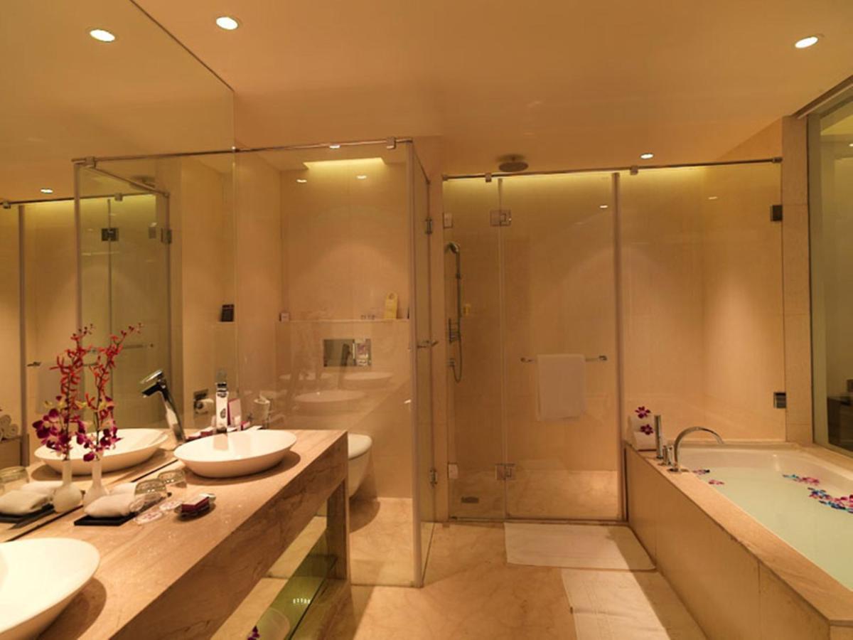 a bathroom with two sinks and a tub and a shower at Hotel Royal Orchid Jaipur, Tonk Road in Jaipur