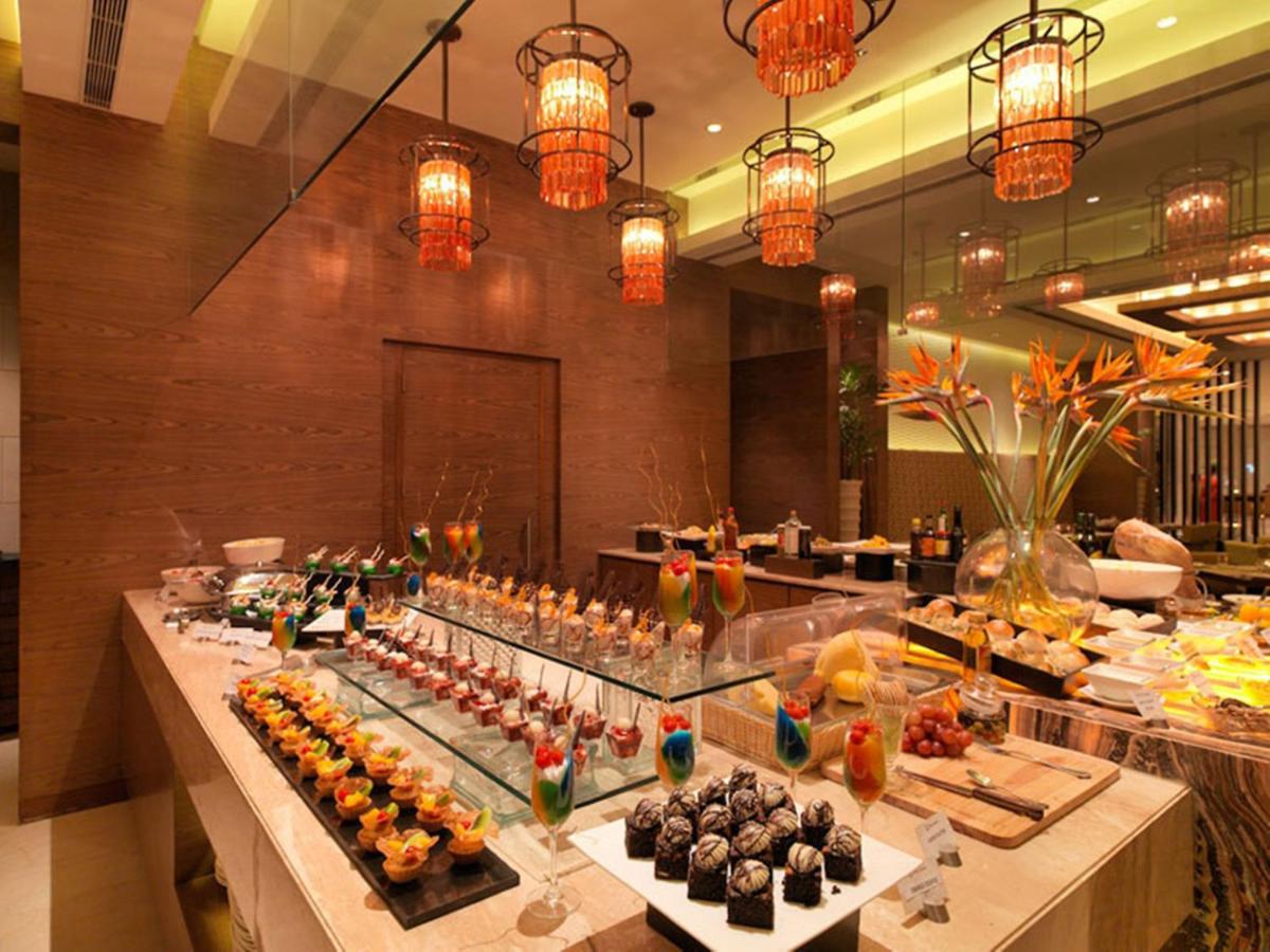 a buffet line with many different types of food at Hotel Royal Orchid Jaipur, Tonk Road in Jaipur