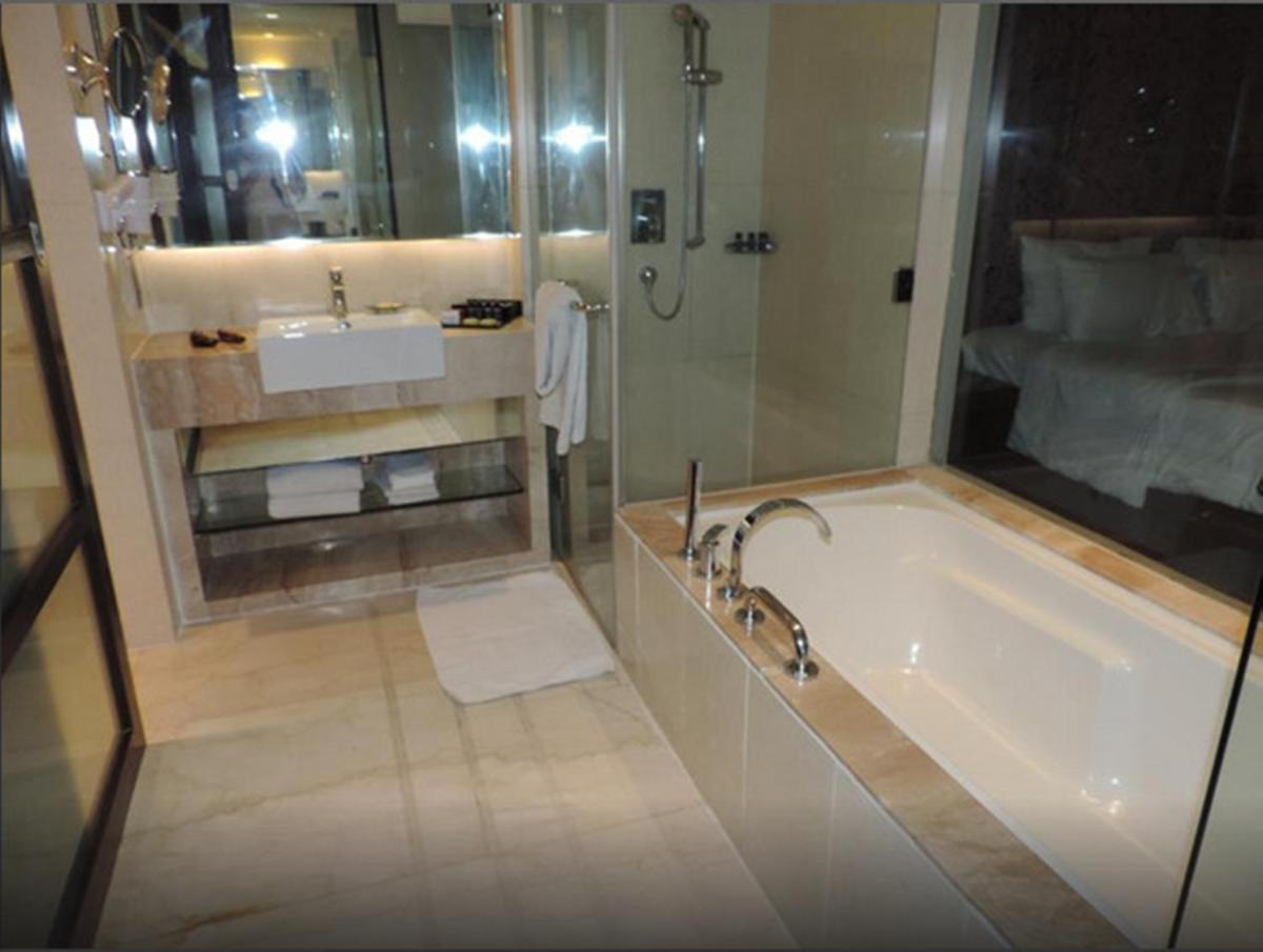 a bathroom with a bath tub and a sink at Hotel Royal Orchid Jaipur, Tonk Road in Jaipur