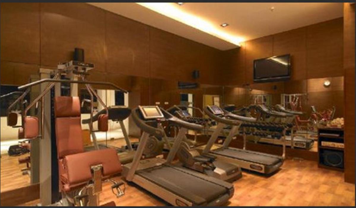 a gym with a bunch of cardio equipment in it at Hotel Royal Orchid Jaipur, Tonk Road in Jaipur