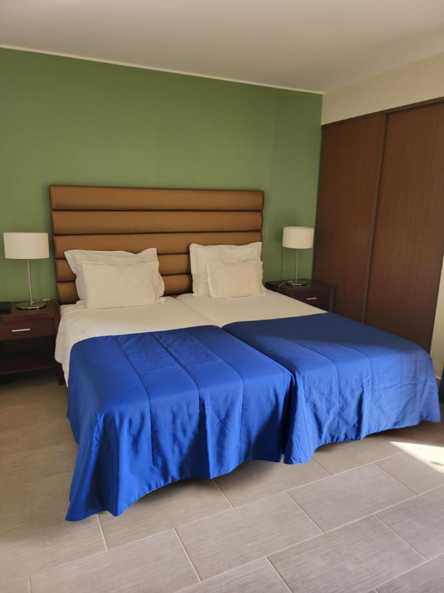 Uma cama ou camas num quarto em Hotel Cais da Oliveira